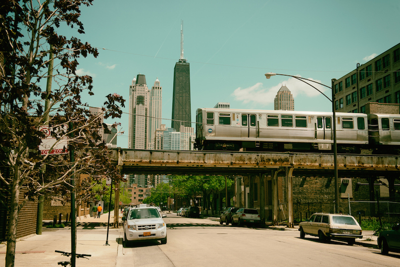 Metra elevated train in front of Chicago skyline